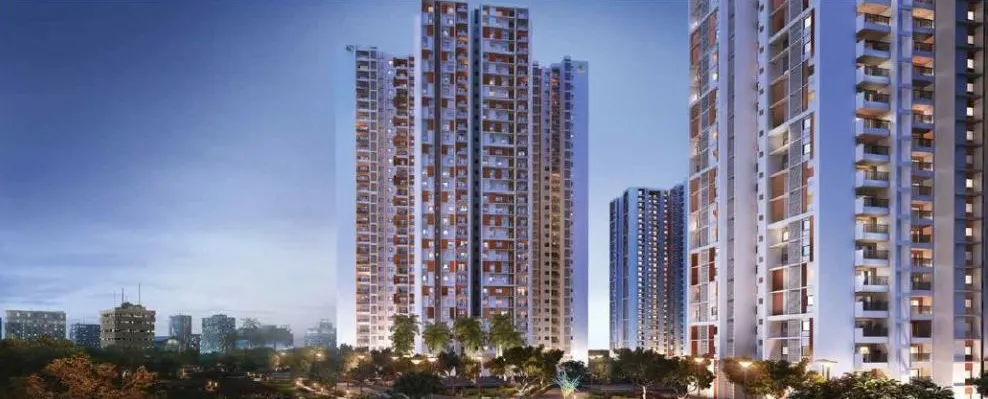 Evening view of the high-rise apartment towers of Prestige Pine Forest with landscaped greenery at their base