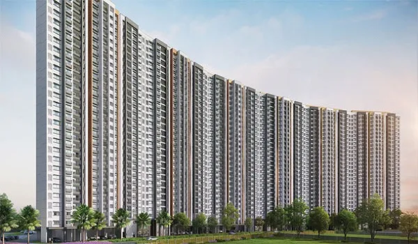 Long curved row of residential towers seen from the landscaped approach road
